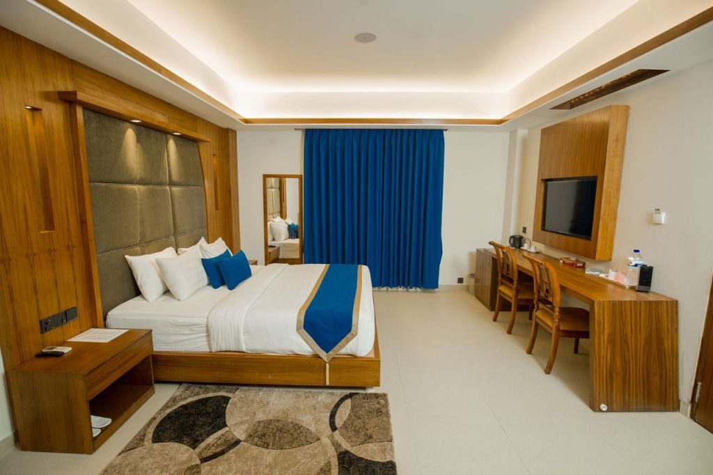 Luxurious hotel room displaying modern interior design with elegant wooden furnishings.